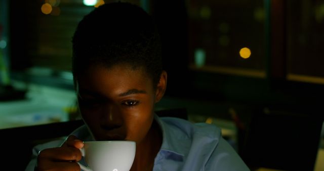 Young Woman Drinking Coffee at Night in Dim Light - Download Free Stock Images Pikwizard.com