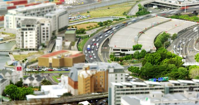 Aerial view of urban highway with heavy traffic and surrounding buildings. This image can be used in urban planning presentations, transportation reports, infrastructure development projects, or articles about city living and modernization.
