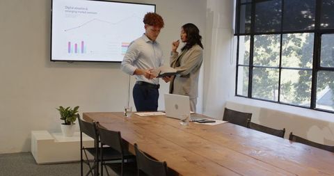 Diverse Business Professionals Analyzing Market Trends in Office Meeting