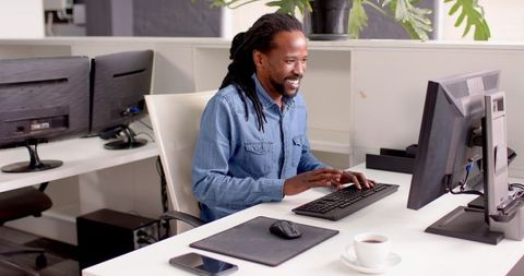 Man Engaged in Computer Work at Modern Office Desk