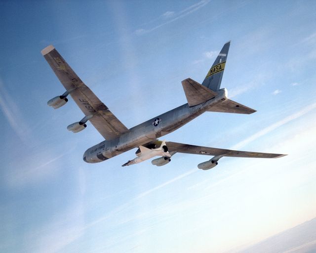 This image captures the historic B-52 mother ship carrying the X-43A and Pegasus booster rocket at high altitude on January 26, 2004, over Edwards Air Force Base. Ideal for use in scientific, aerospace, and historical publications, this image highlights aeronautic engineering and aircraft testing of hydrogen-fueled autonomous aircraft.