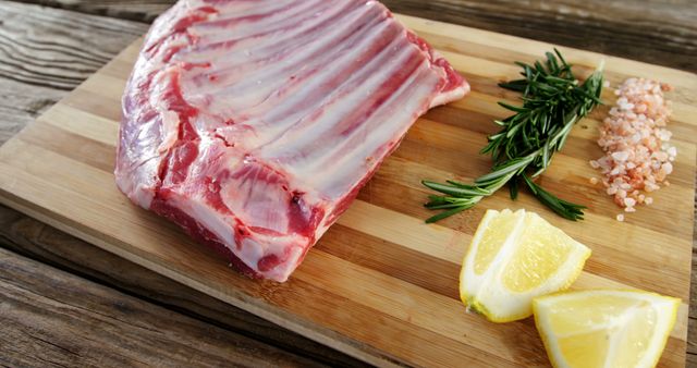 Raw Lamb Ribs with Fresh Herbs and Lemon on Wooden Cutting Board - Download Free Stock Images Pikwizard.com