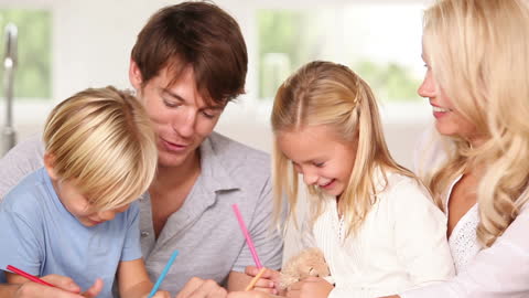 Smiling Family Drawing Together in Bright Kitchen