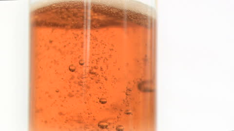 Close-up of Bubbles in Orange Carbonated Drink