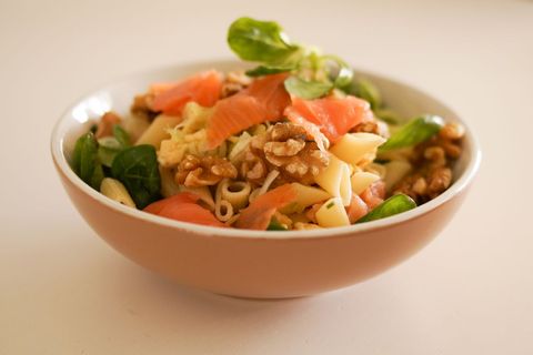 Smoked salmon pasta salad featuring walnuts, baby greens and penne for healthy lunch