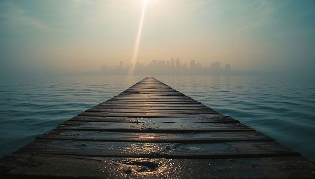 Sunlit Wooden Pier Leading to Misty City Skyline