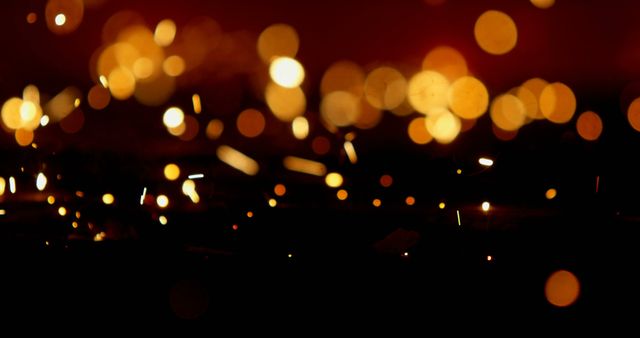 Warm golden bokeh lights and sparkles on a dark background convey a festive, celebratory mood. Ideal for use in holiday promotions, seasonal greetings, party invitations, or as a digital backdrop for websites and social media posts enhancing festive and joyful themes.