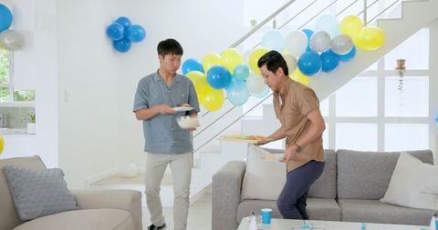 Friends Preparing Home with Balloon Decorations for Festive Celebration