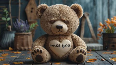 Nostalgic teddy bear holding 'miss you' pillow on rustic autumn deck