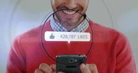 Joyful Man Interacting with Social Media on Smartphone