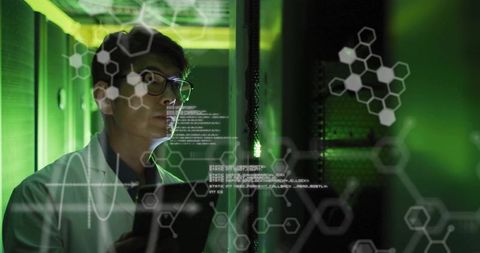 Asian Male Technician Analyzing Data in Futuristic Server Room - Download Free Stock Images Pikwizard.com