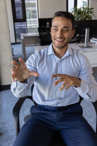 Confident Businessman Engaging in Discussion in Modern Office