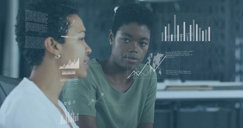 Business Analysts Discussing Financial Data Visualizations in Modern Office