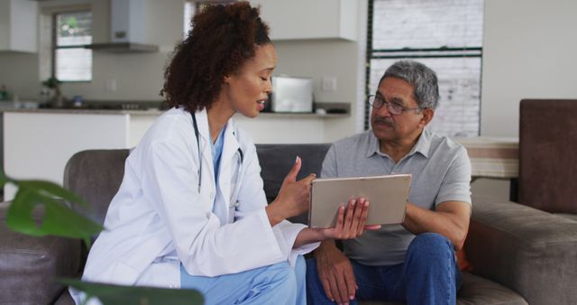 Female Doctor Consulting Elderly Patient at Home Using Tablet - Download Free Stock Images Pikwizard.com