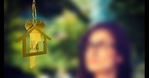 Woman enjoying soothing sounds of house shaped wind chime