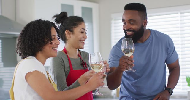 Happy Friends Toasting with Wine in Kitchen - Download Free Stock Images Pikwizard.com