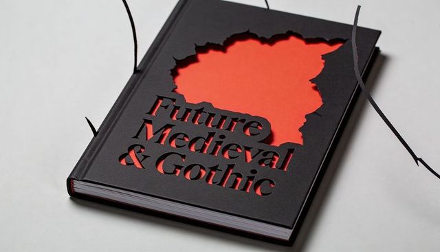 Black die-cut hardcover book with red core, gothic typography and minimalist design