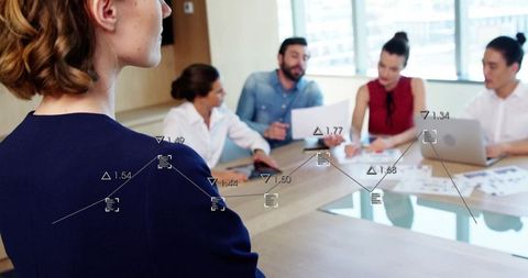 Business Leader Presenting to Multiethnic Team Using Analytics