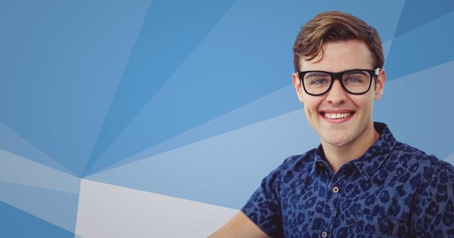 Young man wearing glasses and a casual shirt is smiling while posing against a blue abstract background. Suitable for promotional materials, advertisements, lifestyle blogs, and website headers.