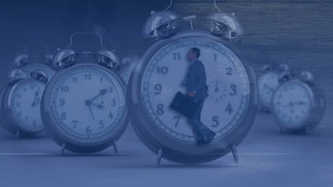 Businessman Racing by Giant Alarm Clocks Depicting Time Management