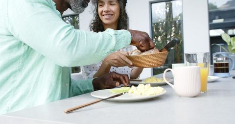 Happy Seated Couple Enjoying Breakfast in Kitchen - Download Free Stock Images Pikwizard.com