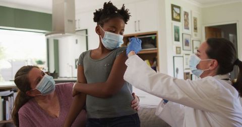 Young Girl Receiving Vaccination from Doctor at Home