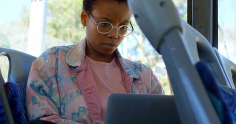 Focused Woman Using Laptop on Bus Commuting Work
