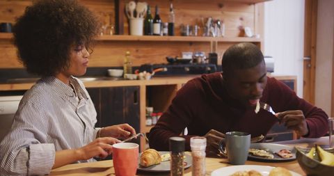 Couple Enjoying Breakfast at Comfortable Home Kitchen Setting