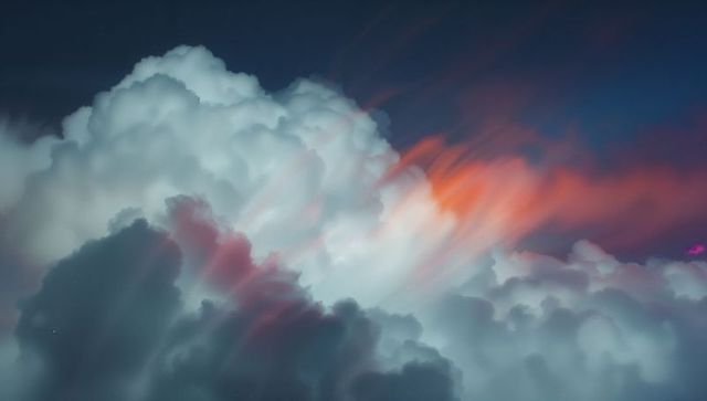 Vibrant cumulus clouds with pink and orange streaks in skyscape
