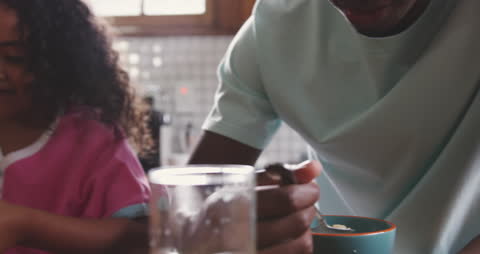 Father and Daughter Eating Breakfast Together at Home