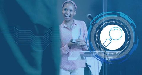 Smiling presenter holding round award at podium with blue digital hud magnifier overlay