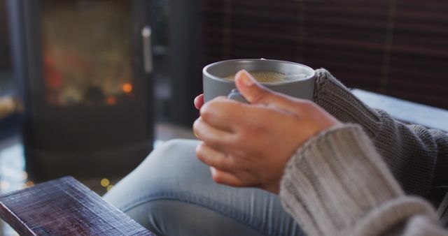 Person Drinking Hot Beverage by Cozy Fireplace - Download Free Stock Images Pikwizard.com