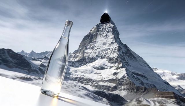 Sunlit Glass Bottle Reflecting Snowy Alpine Peak on Minimalist Ledge for Product Mockup