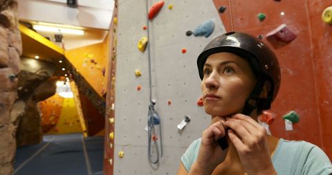 Determined Woman Preparing for Rock Climbing Indoors - Download Free Stock Images Pikwizard.com