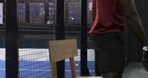 Athlete Preparing for Padel Match at Modern Indoor Court