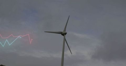 Wind turbine generating electricity in overcast sky