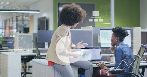 Diverse Colleagues Analyzing Financial Data at Office Workspace