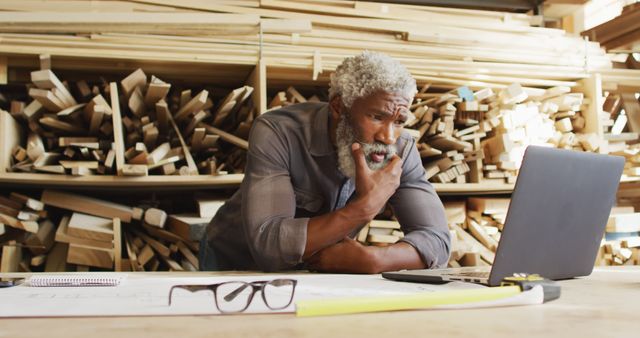 Senior Carpenter Watching Computer Screen in Workshop - Download Free Stock Images Pikwizard.com