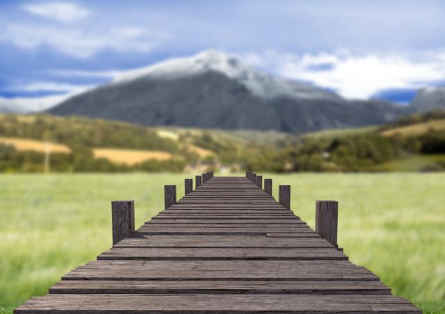 Digital composition of wooden walkway against countryside landscape