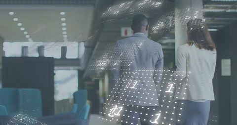 Walking colleagues in modern office with holographic data overlay and glass-walled corridor