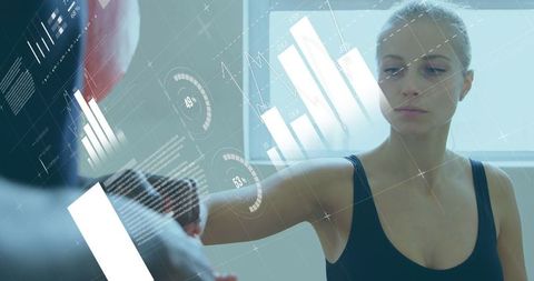 Woman Training in Gym Surrounded by Augmented Reality Data Graphics