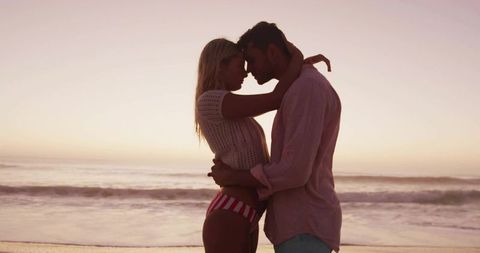 Romantic Beach Couple Enjoying Sunset Near Ocean