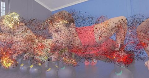 Performing kettlebell push-ups in group fitness showing strength, endurance and teamwork