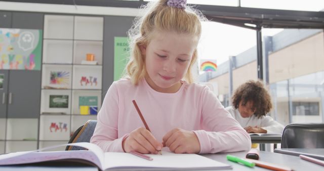 Young Girl Drawing in Classroom with Classmate in Background - Download Free Stock Images Pikwizard.com