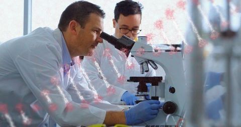 Focused Scientist Examining Microscope in Sterile Lab Environment