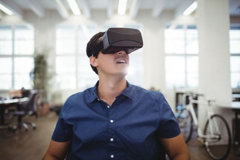 Man Wearing VR Headset in Modern Office Environment - Download Free Stock Images Pikwizard.com