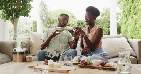 Young Couple Celebrating Anniversary with Dessert and Champagne Outdoors