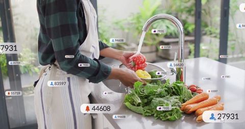 Woman Preparing Vegetables in Modern Kitchen with Attention Counters