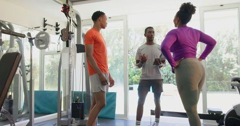 Energetic Couple Discussing Fitness Plans in Home Gym