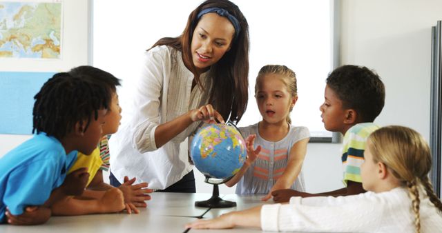 Teacher Explaining Globe to Curious Children in Classroom - Download Free Stock Images Pikwizard.com